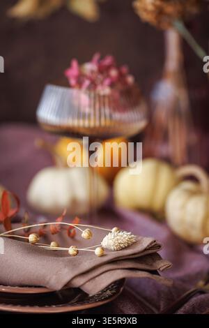 Fall-inspired table setting with pumpkins and dried flowers Stock Photo