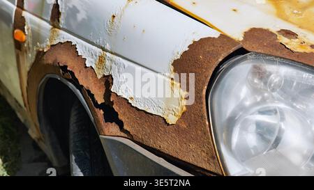 Corroding car body panel showing rust and peeling paint in Moscow Stock Photo