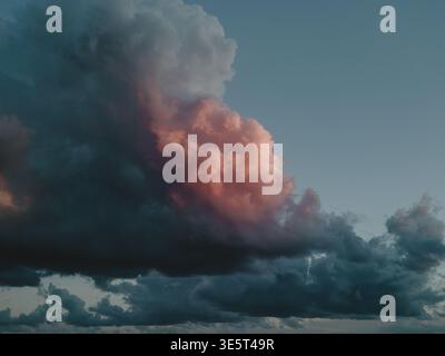 Colorful dramatic sky in blue tones and orange accent  Stock Photo