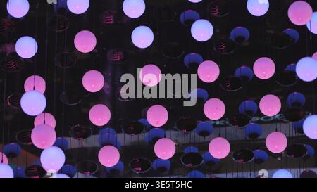 Pink glowing spheres creating a vibrant abstract light installation Stock Photo