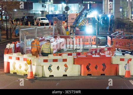 LONDON, UK. 2nd April 2026: Night view of active utility roadworks at the Leamouth Roundabout (A1020) in Tower Hamlets. Following the first anniversary of the Silvertown Tunnel opening, major electrical and cabling repairs continue to disrupt traffic flow at this critical East London transit node. The image shows workers in high-visibility clothing at a floodlit excavation site, documented as part of a forensic audit of ongoing infrastructure friction in the subterranean crossing's perimeter. Credit:xiu bao/Ģ����ý Live News Stock Photo