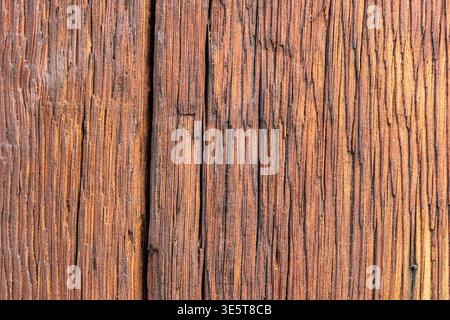 Dark brown weathered wood grain texture, vertical aged timber surface background with deep linear fiber pattern Stock Photo