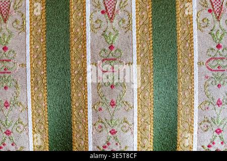 Ornate striped brocade fabric texture, green gold floral woven textile surface background with decorative baroque pattern Stock Photo