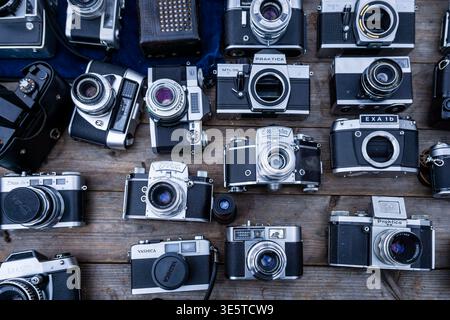 Collection of vintage analog film cameras displayed on a flea market table at Boxhagener Platz in Berlin Friedrichshain, Berlin, Germany. Stock Photo