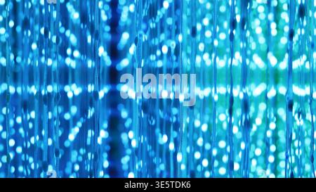 Glowing blue light dots creating abstract futurism and technology pattern bokeh Stock Photo