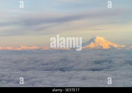 Mount Rainier rises above a sea of clouds at sunset, Washington state. Stock Photo