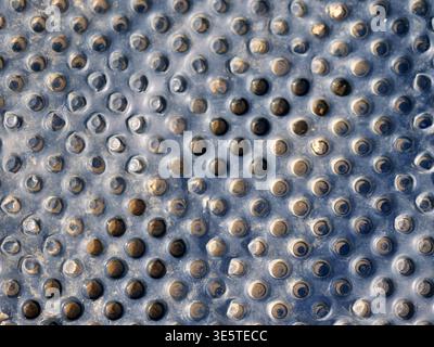 Dimpled drainage membrane close-up, black HDPE foundation sheet, macro texture of plastic  waterproofing material, industrial construction barrier pat Stock Photo