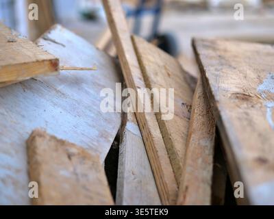 Close-up of a dark grey tiled floor covered in white plaster dust and debris, industrial renovation  scene showing messy cleanup after wall demolition Stock Photo