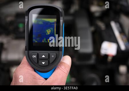 Service temperature inspection of motor engine with thermal infrared camera imager thermographic check Stock Photo