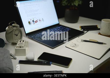 Laptop on table at living room in the night. Home office workpalce with laptop. Overworking and night working concept Stock Photo