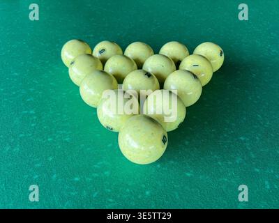 racked billiard balls on a green table ready for a game concept of leisure and competition Stock Photo