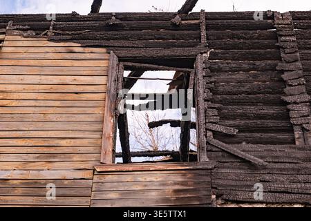 Burnt house structure showing extensive fire damage and destructive aftermath Stock Photo