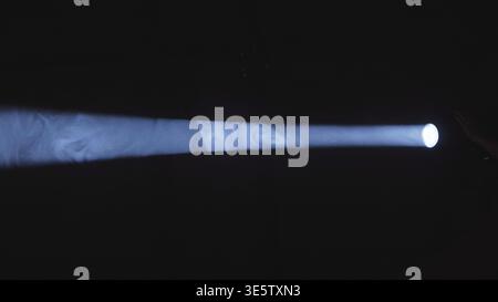 Light beam projecting through smoke creating atmospheric abstract texture in darkness Stock Photo
