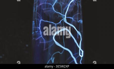 Blue electric plasma discharge creating light patterns in a science demonstration Stock Photo