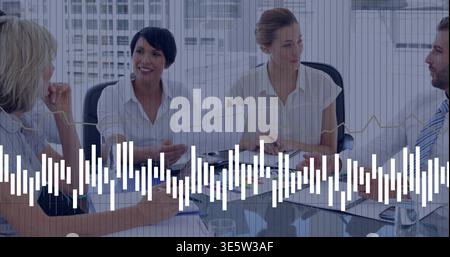 Reviewing team of four in business attire discussing reports in conference room with waveform Stock Photo