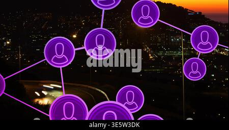 Displaying neon purple user-node icons connecting lines over coastal city sunset with light trails Stock Photo
