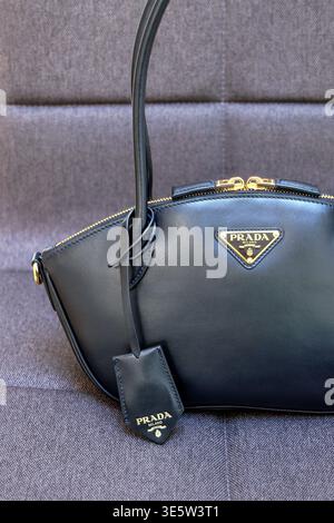 Details and logo of a black Prada handbag Stock Photo