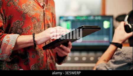 Hands, tablet or audio technician in recording studio, digital editing software or music production. Mixing app, tech or person with sound effects for Stock Photo