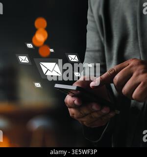 Person using smartphone sending email message with digital mail icons email with notification alert, Online. Concept mobile communication, online mess Stock Photo