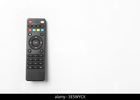 Modern TV remote controls on grey background Stock Photo