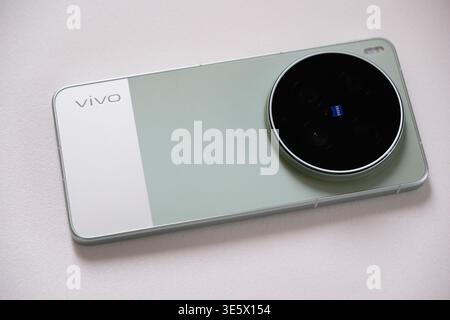 Shanghai,China-April 3rd 2026: close-up a green Vivo X300 Ultra smartphone, circular ZEISS camera module on back Stock Photo