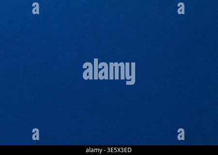 Deep blue textured paper background with subtle gradient for versatile design and copy space Stock Photo