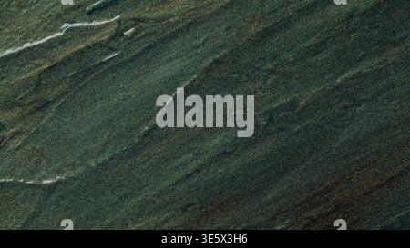 Abstract dark green textured surface with diagonal brush strokes and metallic shimmer effect Stock Photo