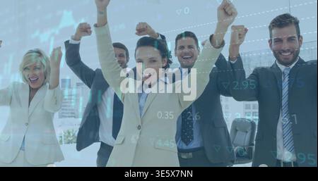 Celebrating team of five in suits, raising fists in conference with tall windows and data overlay Stock Photo