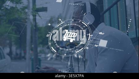 Sitting man in button shirt, over-ear headphones, checking phone at bus stop, HUD cart, copy space Stock Photo