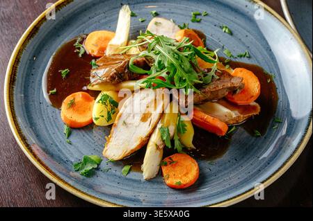 stewed vegetables with meat and arugula Stock Photo