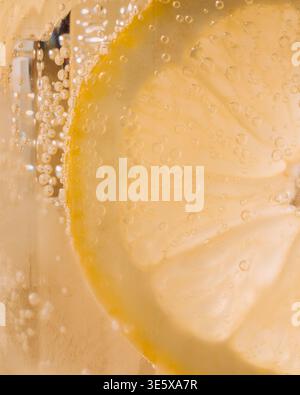 close up macro shot of a lemon in a glass of lemonade Stock Photo