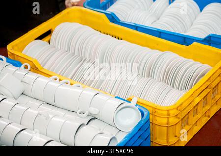 Stacked white ceramic cups and plates Stock Photo