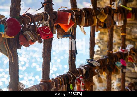 Red Love lock. Padlocks with hearts over the sea in Italy on the coast. Stock Photo