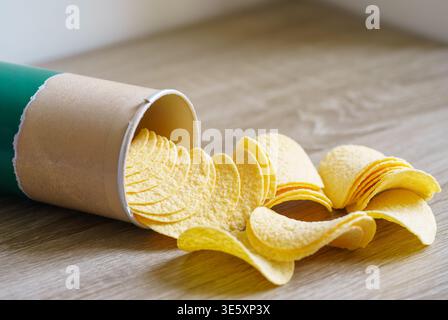 Stack of crispy potato chips in a cardboard tube, classic salted flavor, snack concept, crunchy texture, close-up food photography Stock Photo