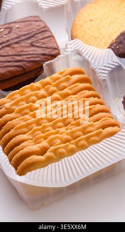 Close-up of different cookies and biscuits neatly arranged in a plastic container. Stock Photo