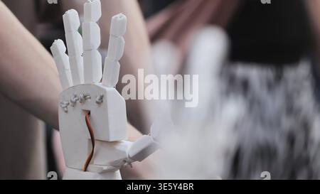 Robotic prosthetic hand prototype. Close up of a 3D printed bionic arm with visible wiring Stock Photo