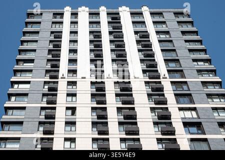 Symmetrical facade of modern residential building with repeating windows pattern for real estate and urban architecture concepts Stock Photo