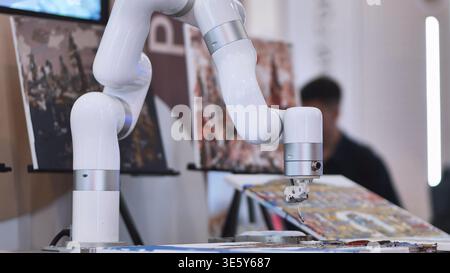 Robot arm painting art on canvas at technology exhibition, artificial intelligence Stock Photo