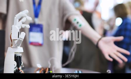 Bionic hand experiment with myoelectric sensors on a human arm at a technology fair Stock Photo
