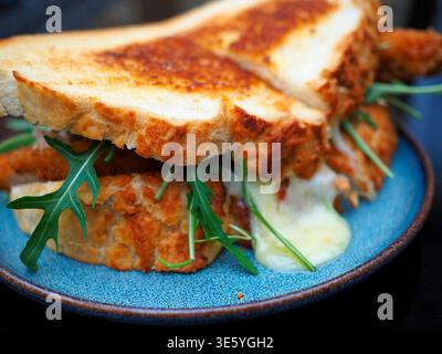 Grilled Cheese Toastie on a blue plate Stock Photo