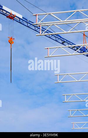 construction site with crane and scaffolding against blue sky. Free copy space Stock Photo