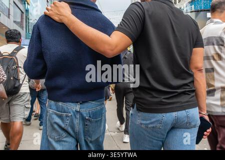 Kuala Lumpur, Malaysia-February 18, 2026: Two gay men walk on street in largely Muslim area in the capital of Malaysia. Stock Photo