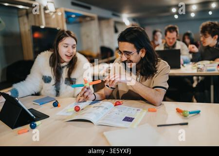 Young students collaborating on a hands-on science project in a modern classroom setting Stock Photo