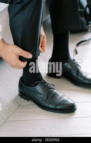 Thoughtfully Getting Ready For Special Event With Precise Motions And Focus Stock Photo