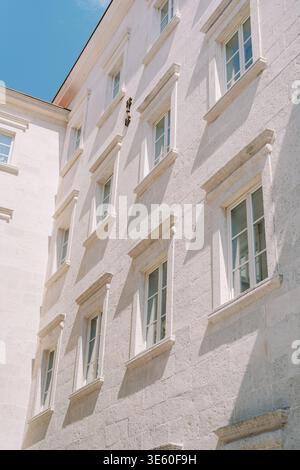Quiet City Scene Featuring Ornate Windows And Clear Blue Sky Stock Photo