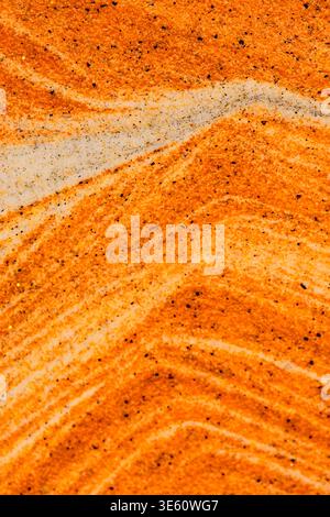 Abstract view swirling orange and white sand layers. Dynamic curves creating natural, marble like sand texture Stock Photo