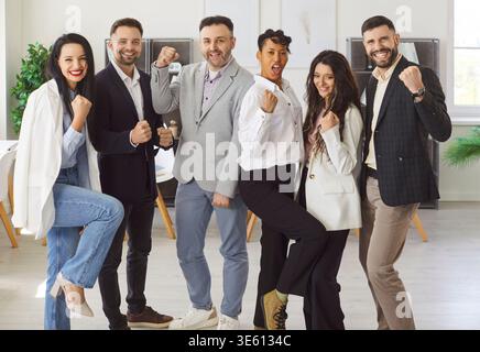 Six young multiethnic teammates celebrating joint success Stock Photo