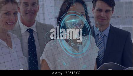 Standing group of four wearing business attire posing in corporate lobby, with blue HUD and folder Stock Photo