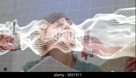 Scanning woman in medical gown looking upward in clinic room, with sensors, folder, AR overlay Stock Photo