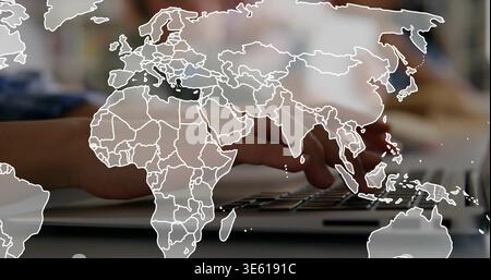 Typing hands tapping laptop keyboard at desk, displaying transparent world map overlay and paper Stock Photo